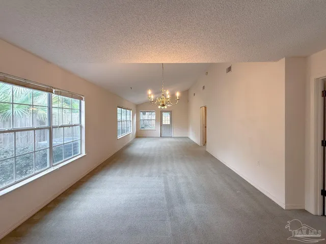 a view of a hallway with windows