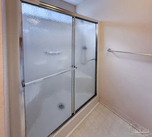 a bathroom with a glass shower door