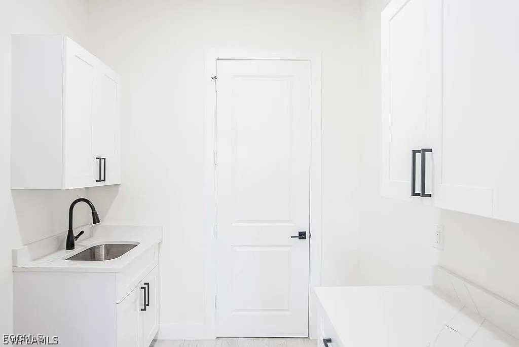2912 45th Street Southwest Lehigh Acres, FL 33976 - Photo 12 of 12 a bathroom with a sink and mirror