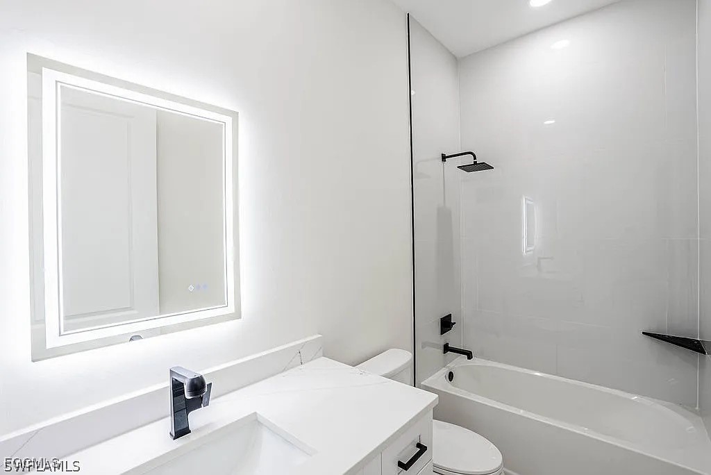 2912 45th Street Southwest Lehigh Acres, FL 33976 - Photo 10 of 12 a bathroom with a sink a toilet and shower