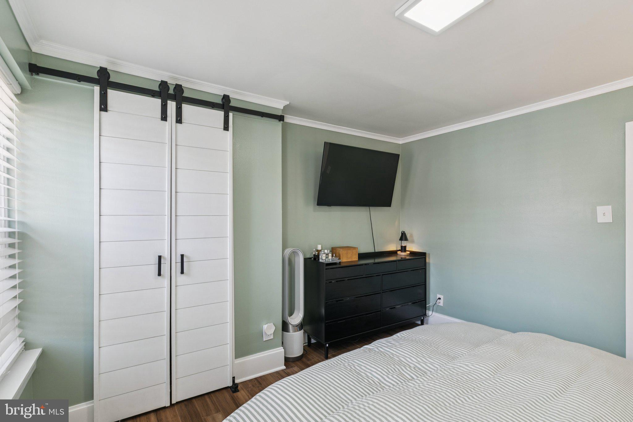 2412 Madison Square Philadelphia, PA 19146 - Photo 20 of 39 a bedroom with a bed and a flat tv screen on a dresser