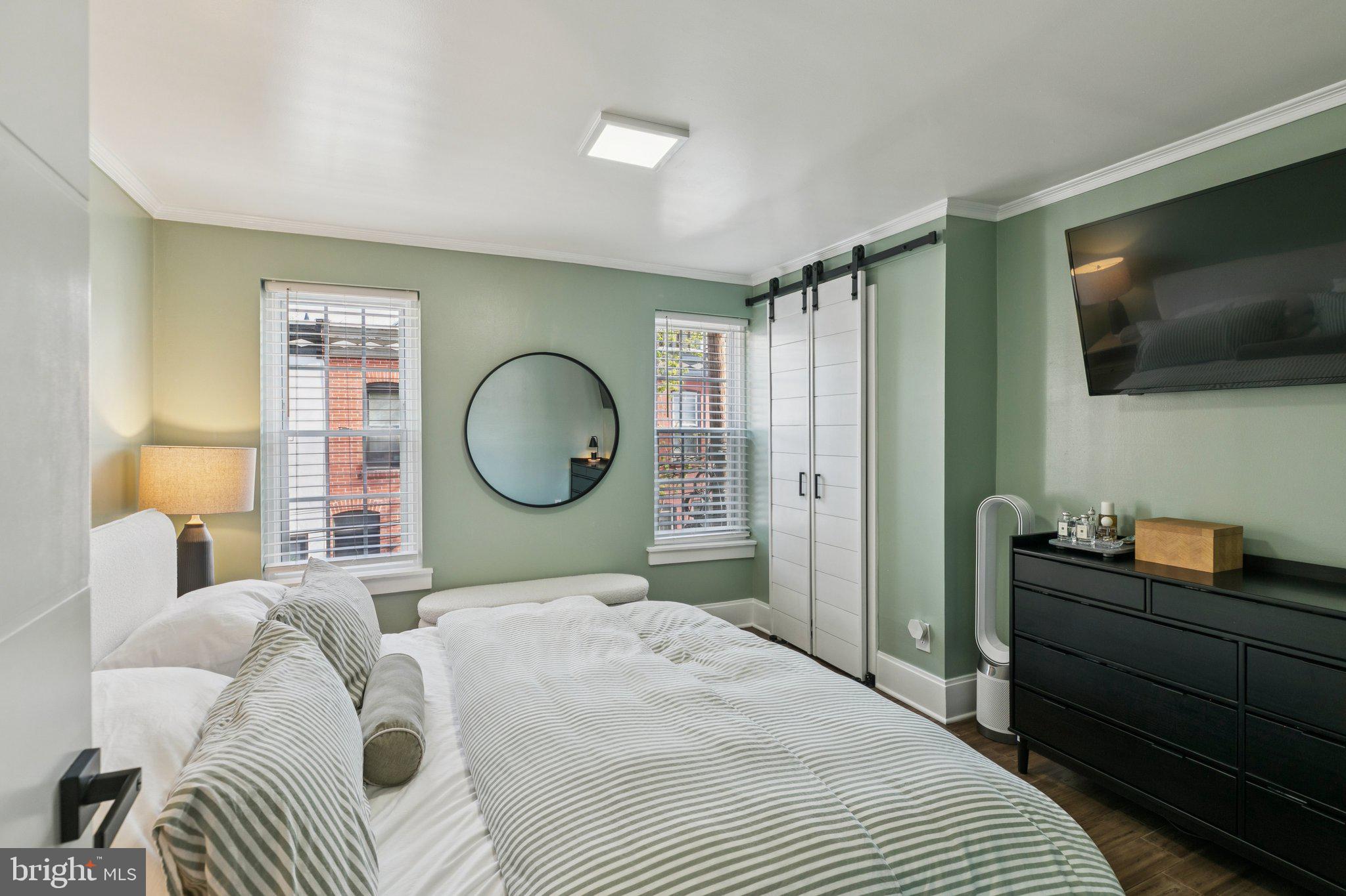 2412 Madison Square Philadelphia, PA 19146 - Photo 23 of 39 a bedroom with a large bed and a flat tv screen on dresser