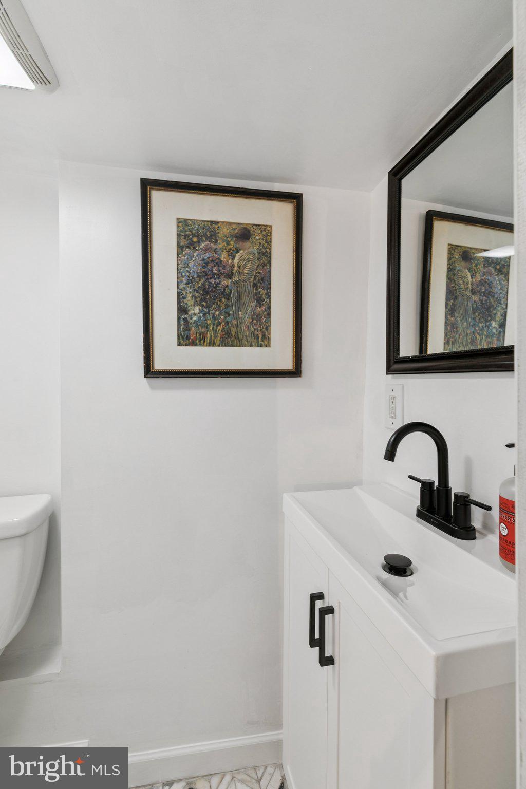 2412 Madison Square Philadelphia, PA 19146 - Photo 31 of 39 a bathroom with a sink and a mirror