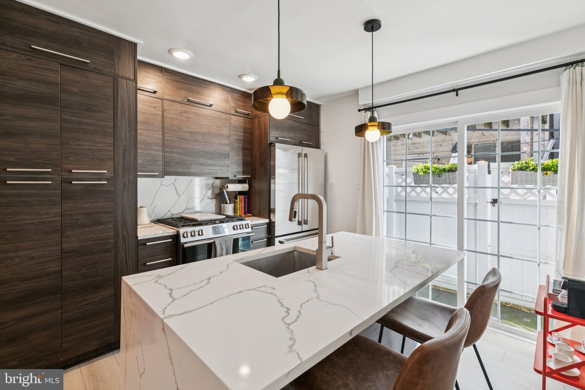 2412 Madison Square Philadelphia, PA 19146 - Photo 10 of 39 a kitchen with a table chairs and a chandelier