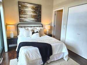 660 West Wayman Street, Unit 501 Chicago, IL 60661 - Photo 12 of 24 a bedroom with a bed and wooden floor