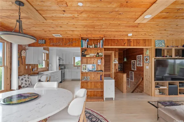 a living room with stainless steel appliances kitchen island granite countertop furniture and a kitchen view