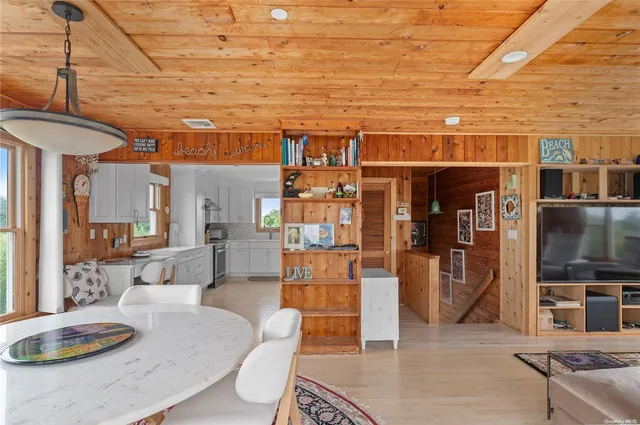 a living room with stainless steel appliances kitchen island granite countertop furniture and a kitchen view