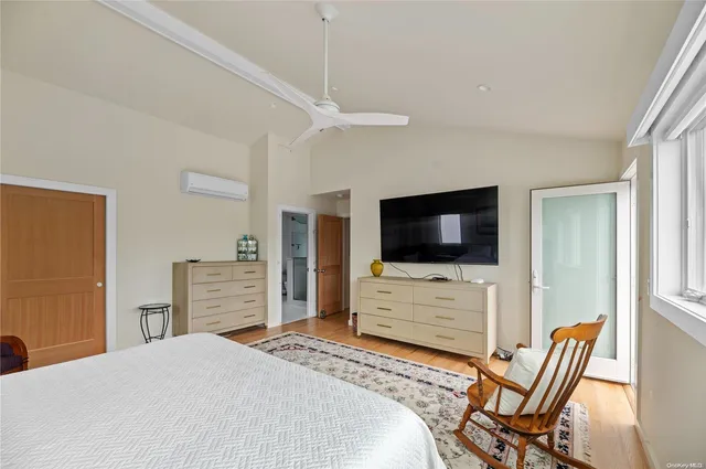 a bedroom with a bed and flat screen tv