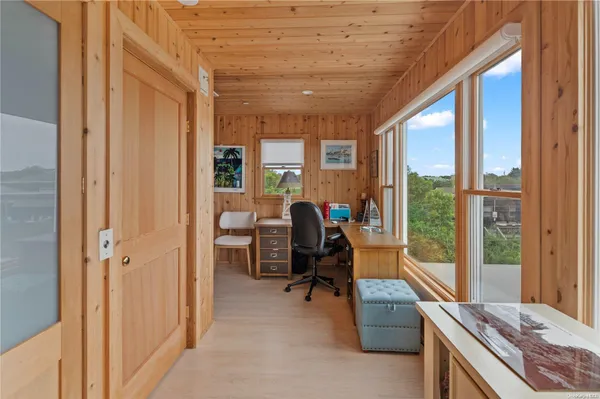a view of a livingroom with workspace and a window