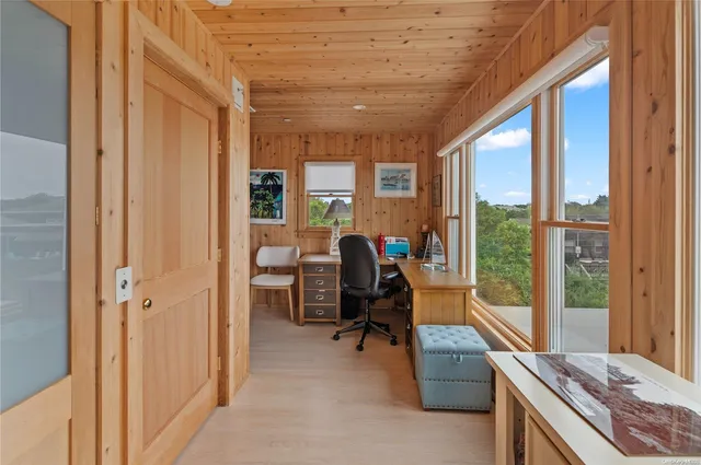 a view of a livingroom with workspace and a window