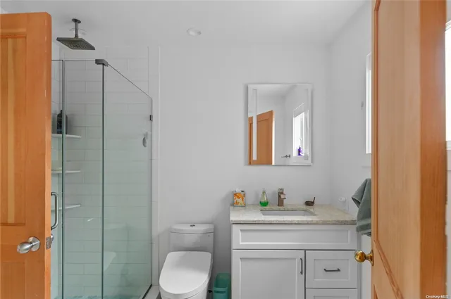 a bathroom with a toilet a sink and mirror