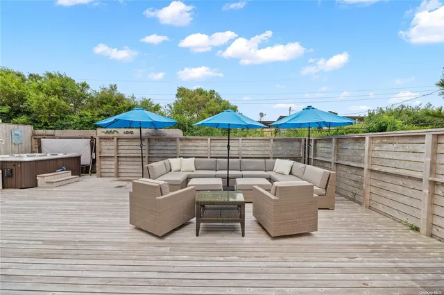 a view of a terrace with couches and wooden floor