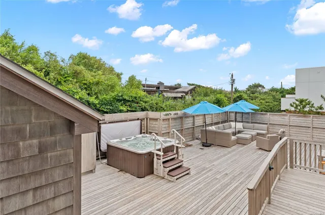 a view of a terrace with furniture and a garden