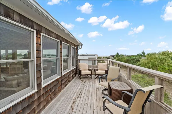 a view of a balcony with chairs