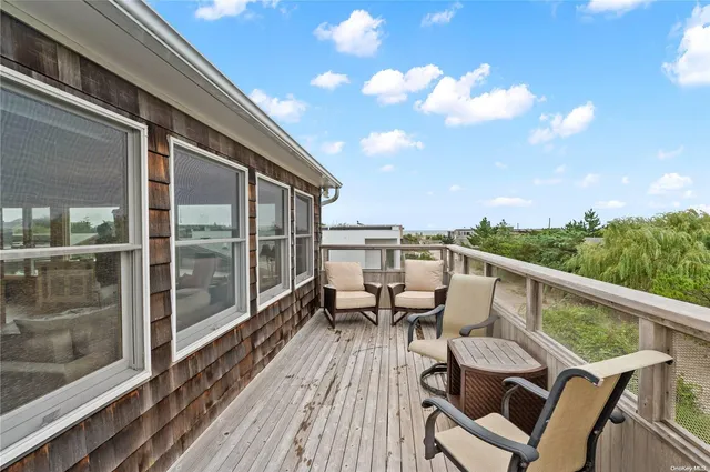 a view of a balcony with chairs