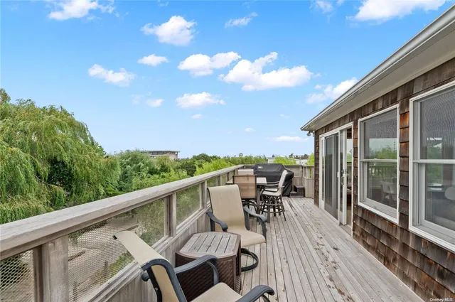 a view of a balcony with chairs and a table