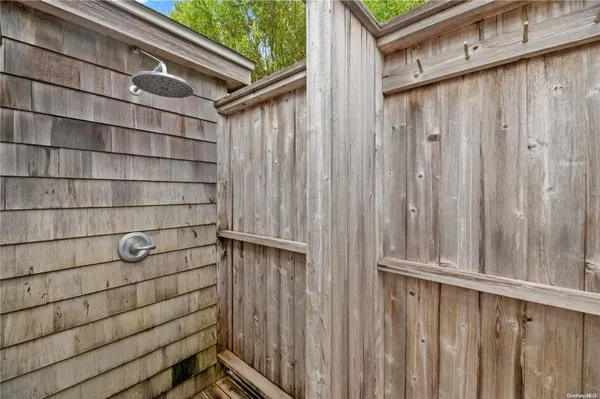 a view of a wooden door and wooden bench