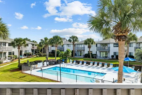 a view of a house with swimming pool and sitting area