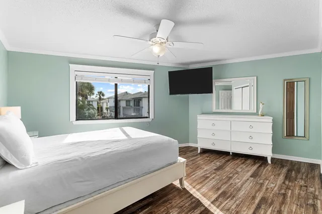 a bedroom with a large bed and a tv on dresser