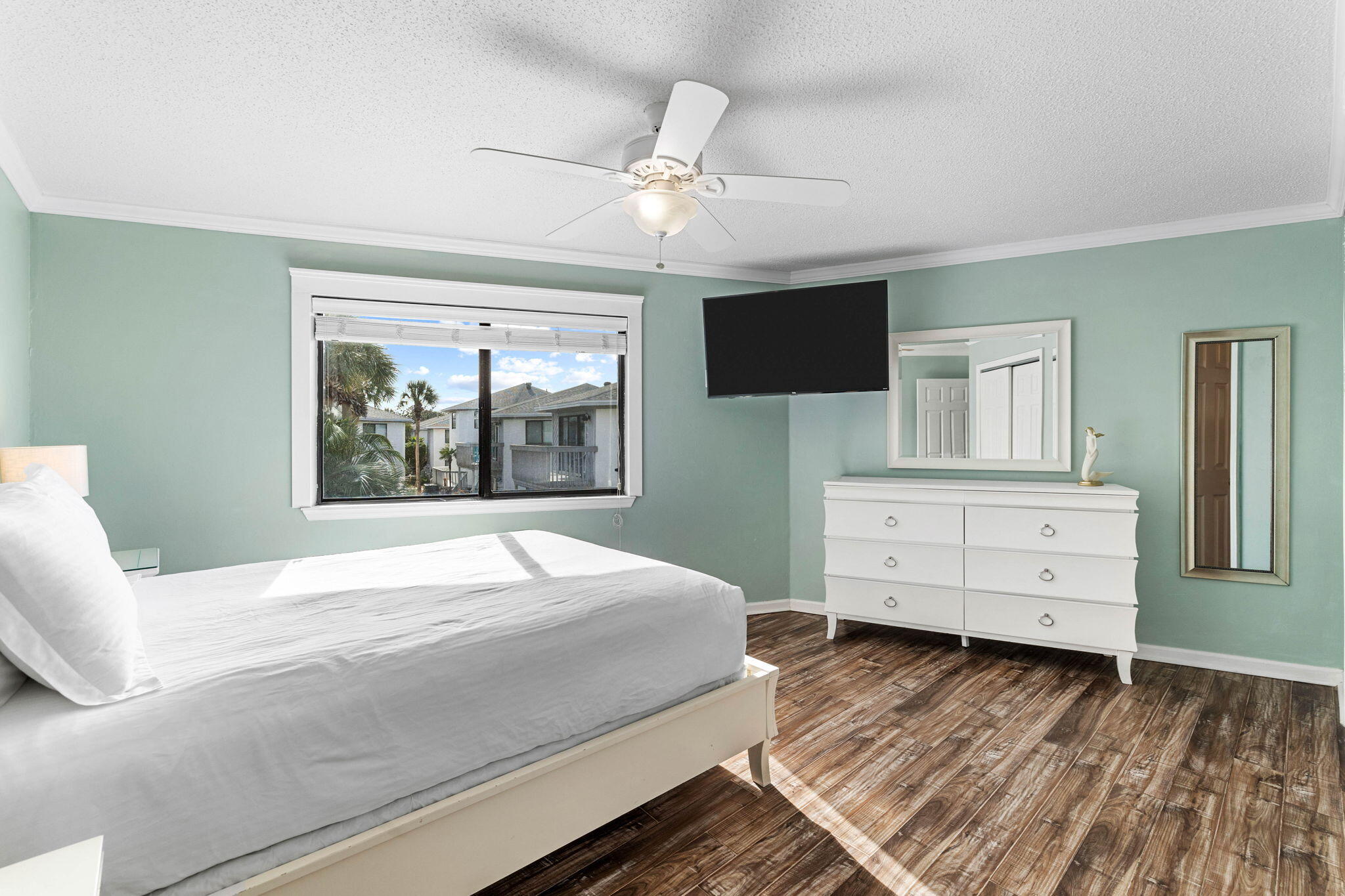 285 Payne Street, Unit 19B Destin, FL 32550 - Photo 14 of 29 a bedroom with a large bed and a tv on dresser