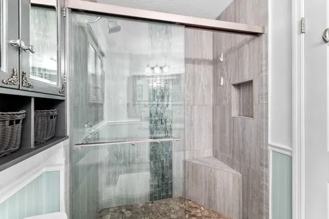 a bathroom with a glass shower door