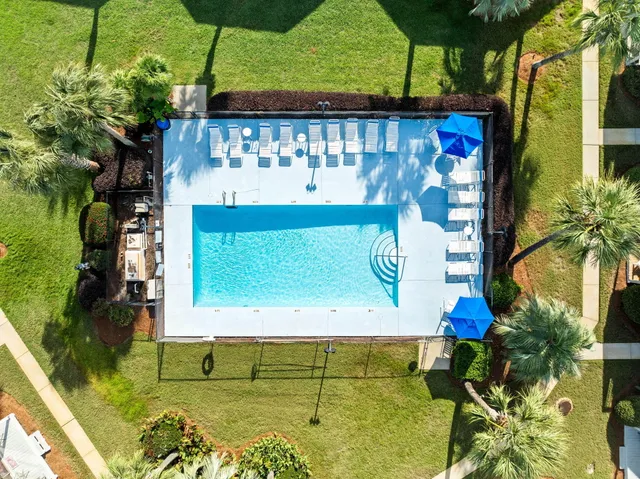 a view of a swimming pool with outdoor seating