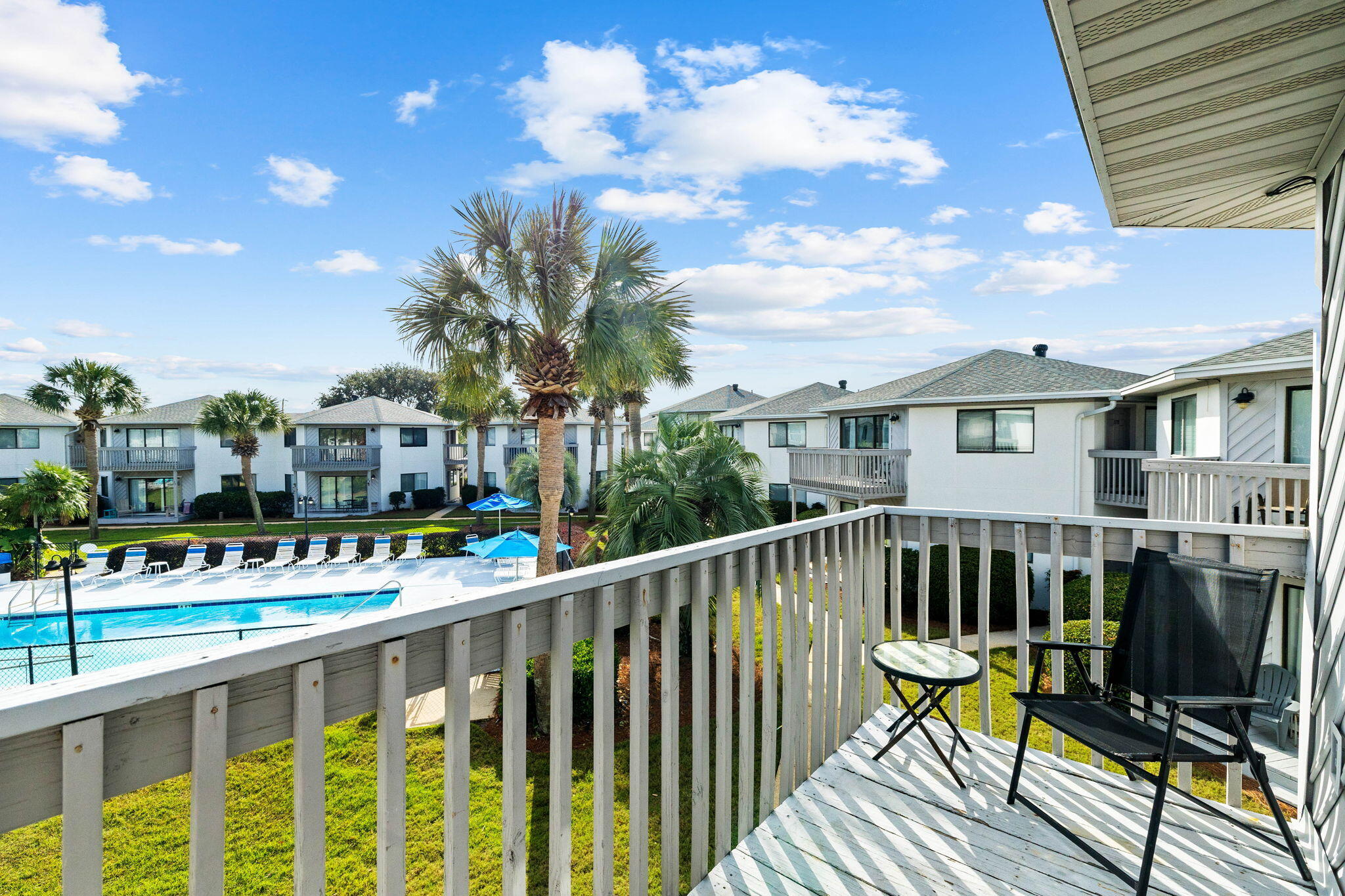 285 Payne Street, Unit 19B Destin, FL 32550 - Photo 3 of 29 a view of a chair and tables on the deck