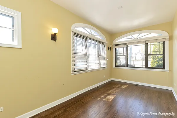 a view of a livingroom with a fireplace wooden floor and staircase