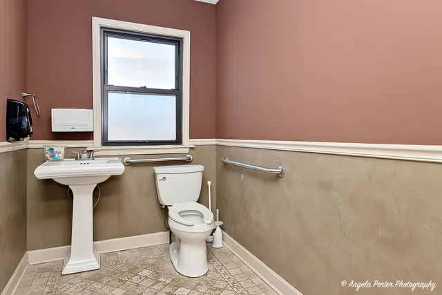 a view of a room with lounge chair wooden floor and windows
