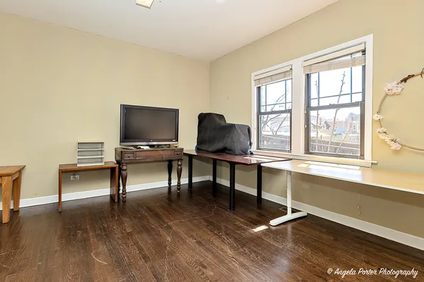 a view of a room with wooden floor and windows