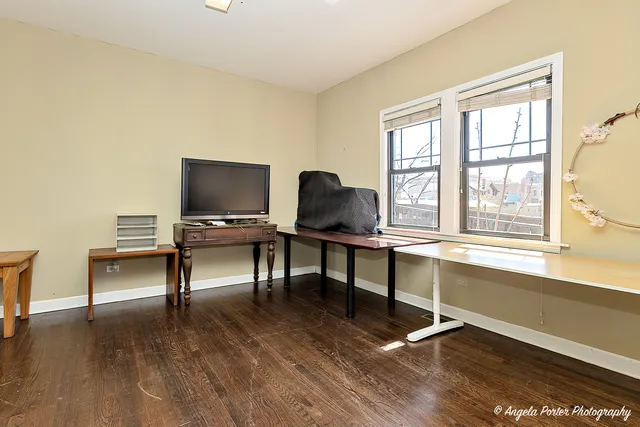 a view of a room with wooden floor and windows