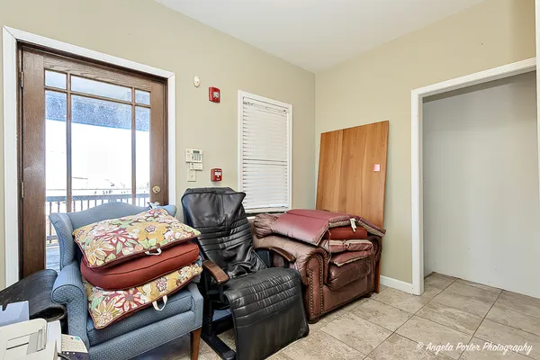 a living room with furniture and hard wood flooring