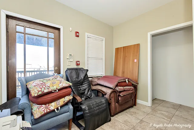 a living room with furniture and hard wood flooring