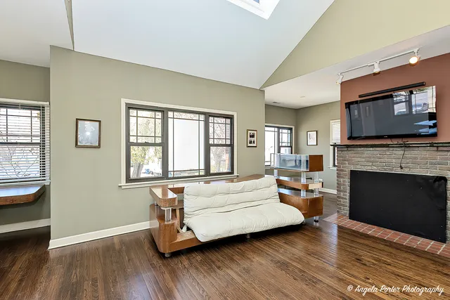 a living room with furniture a fireplace and a flat screen tv