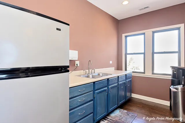a bathroom with a granite countertop sink a toilet a mirror and shower