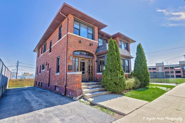 a view of a house with a wooden fence