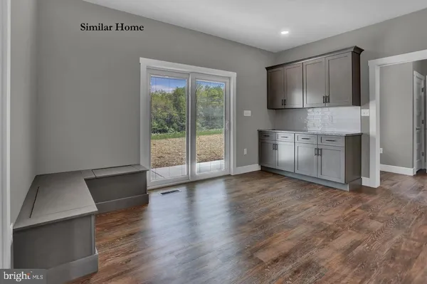 a view of a kitchen with a stove cabinets and wooden floor
