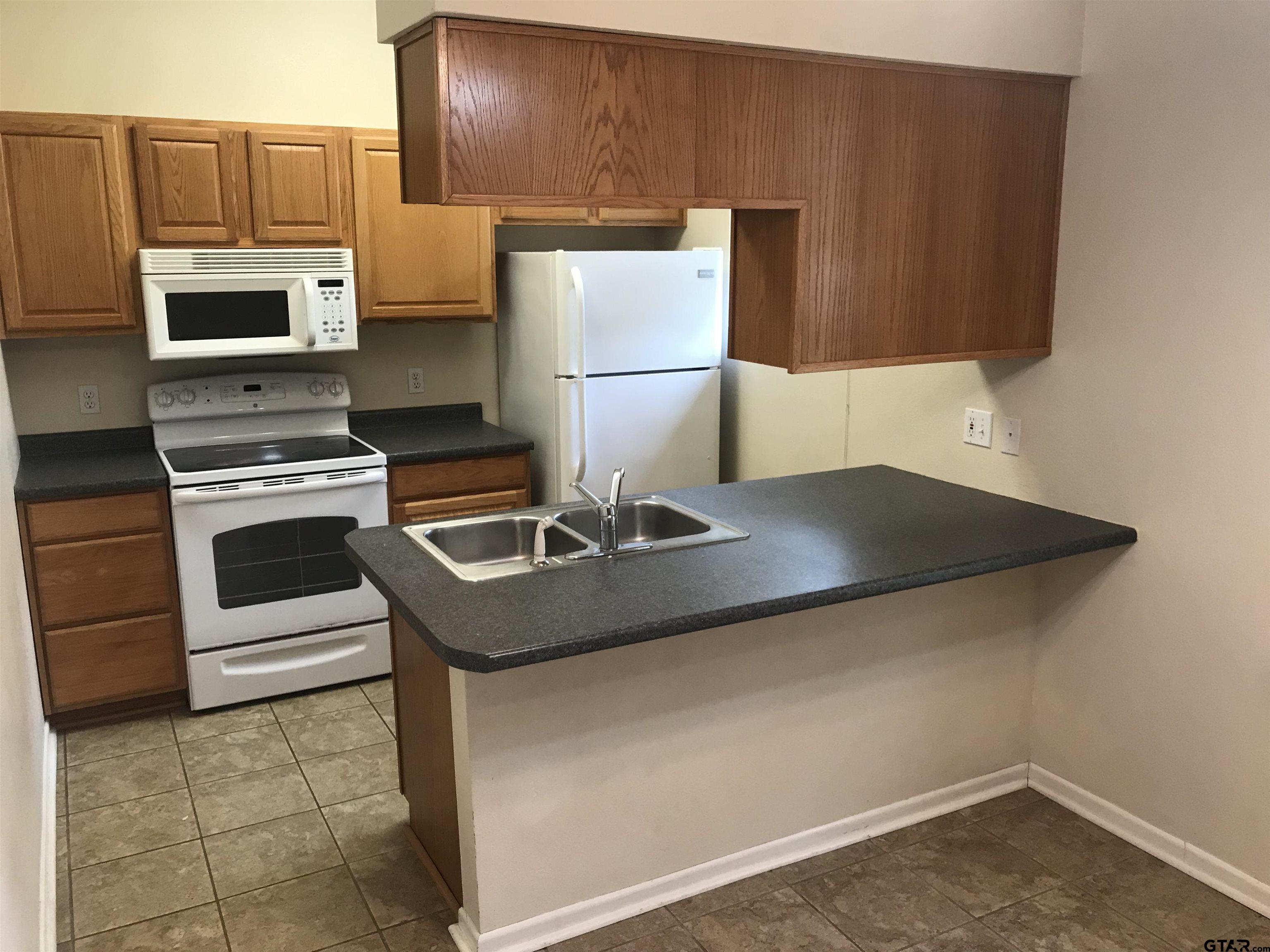 19044 FM 2493 Flint, TX 75762 - Photo 11 of 20 a kitchen with a sink a stove and cabinets