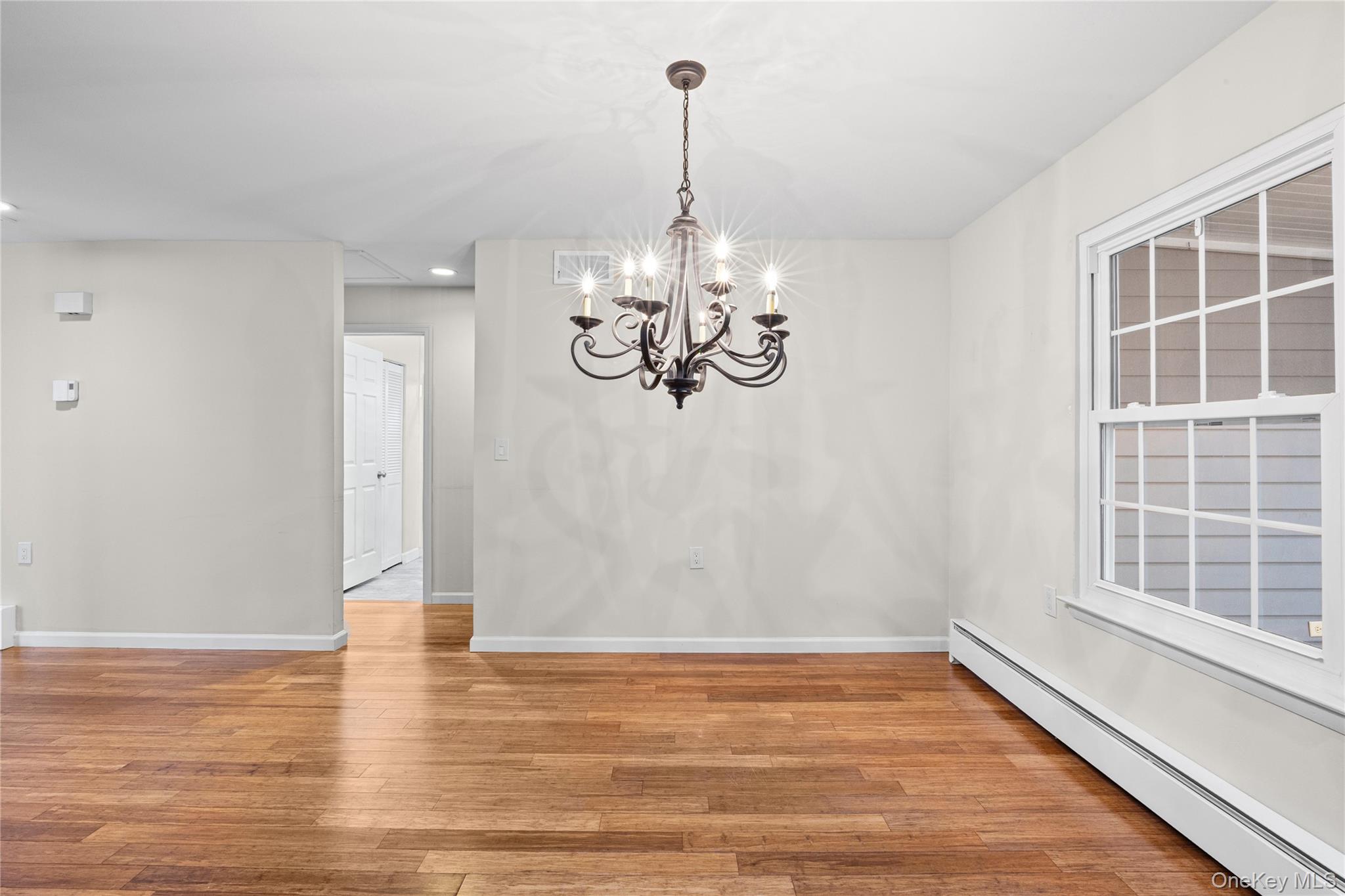 220 Belfast Lane Ridge, NY 11961 - Photo 26 of 44 a view of empty room with wooden floor and fan