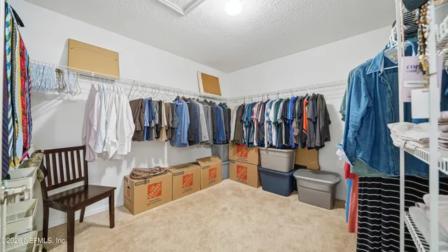 a bedroom with bed and a chandelier