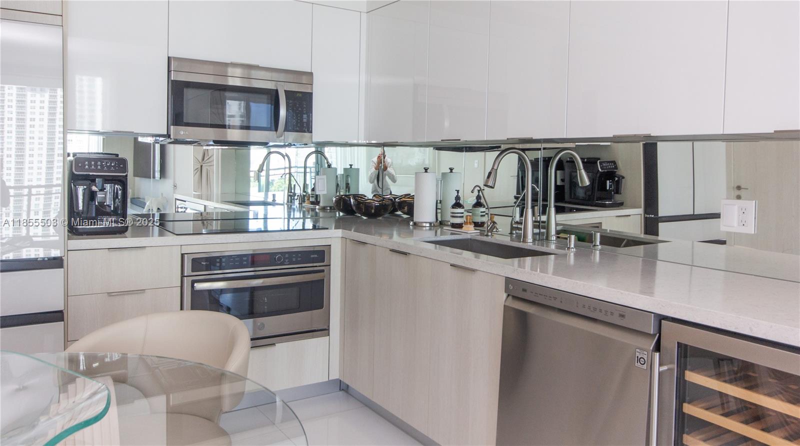 92 Southwest 3rd Street, Unit 1711 Miami, FL 33130 - Photo 11 of 54 a kitchen with stainless steel appliances a sink and a stove