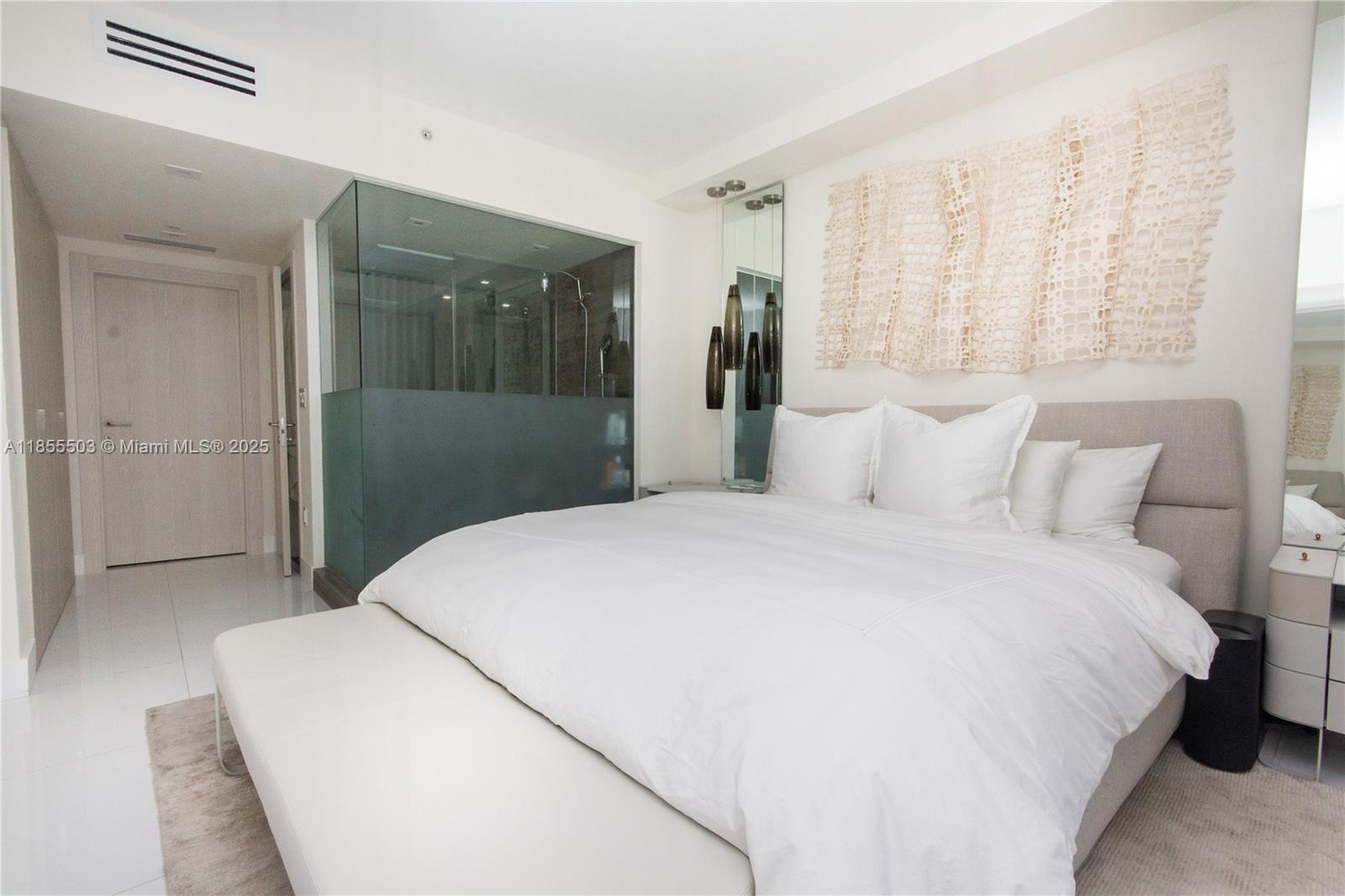 92 Southwest 3rd Street, Unit 1711 Miami, FL 33130 - Photo 17 of 54 a bedroom with a bed and a large mirror