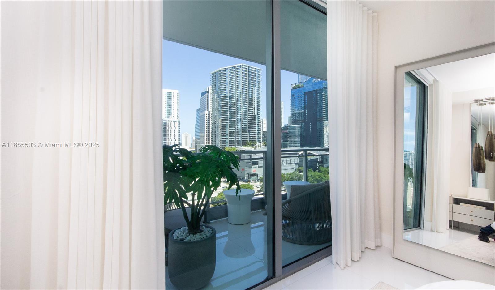 92 Southwest 3rd Street, Unit 1711 Miami, FL 33130 - Photo 22 of 54 a potted plant in front of a glass door