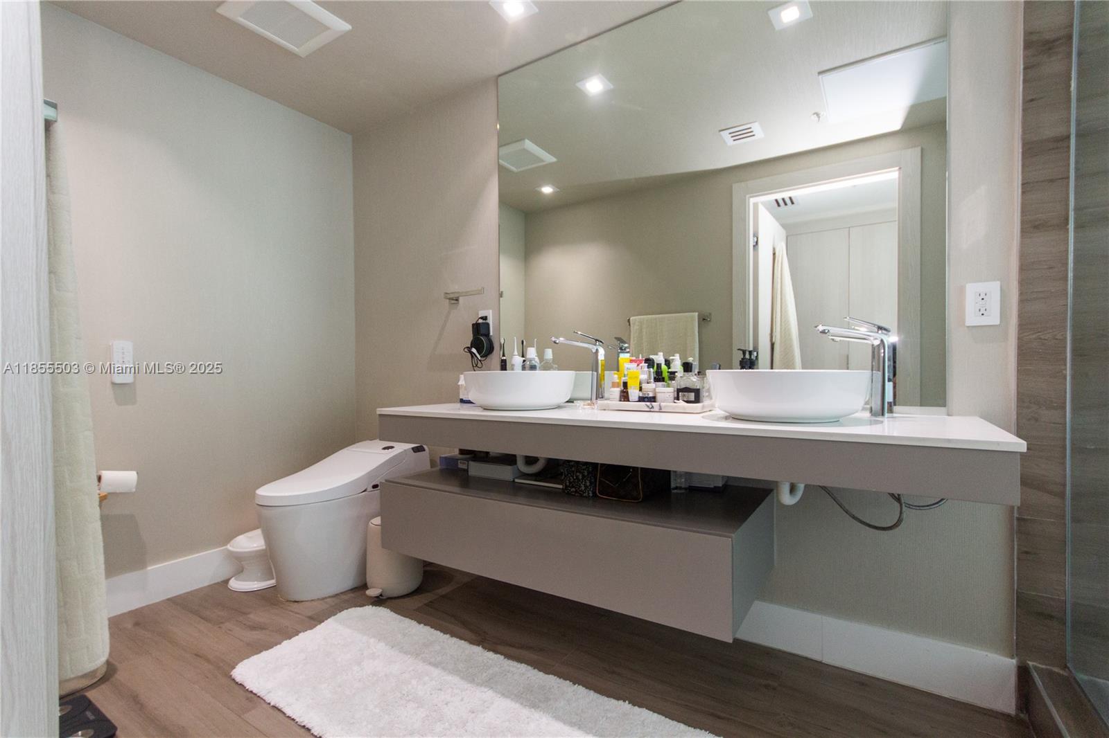 92 Southwest 3rd Street, Unit 1711 Miami, FL 33130 - Photo 30 of 54 a bathroom with a sink and a toilet