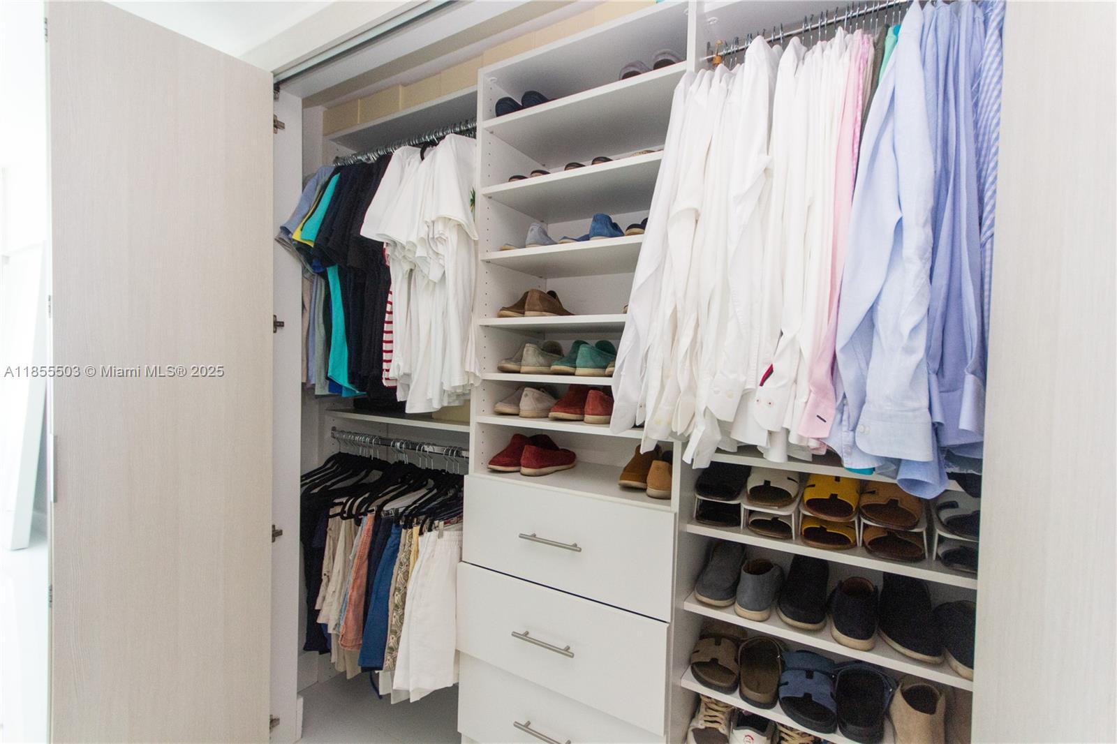 92 Southwest 3rd Street, Unit 1711 Miami, FL 33130 - Photo 34 of 54 a view of walk in closet with clothes and shoes