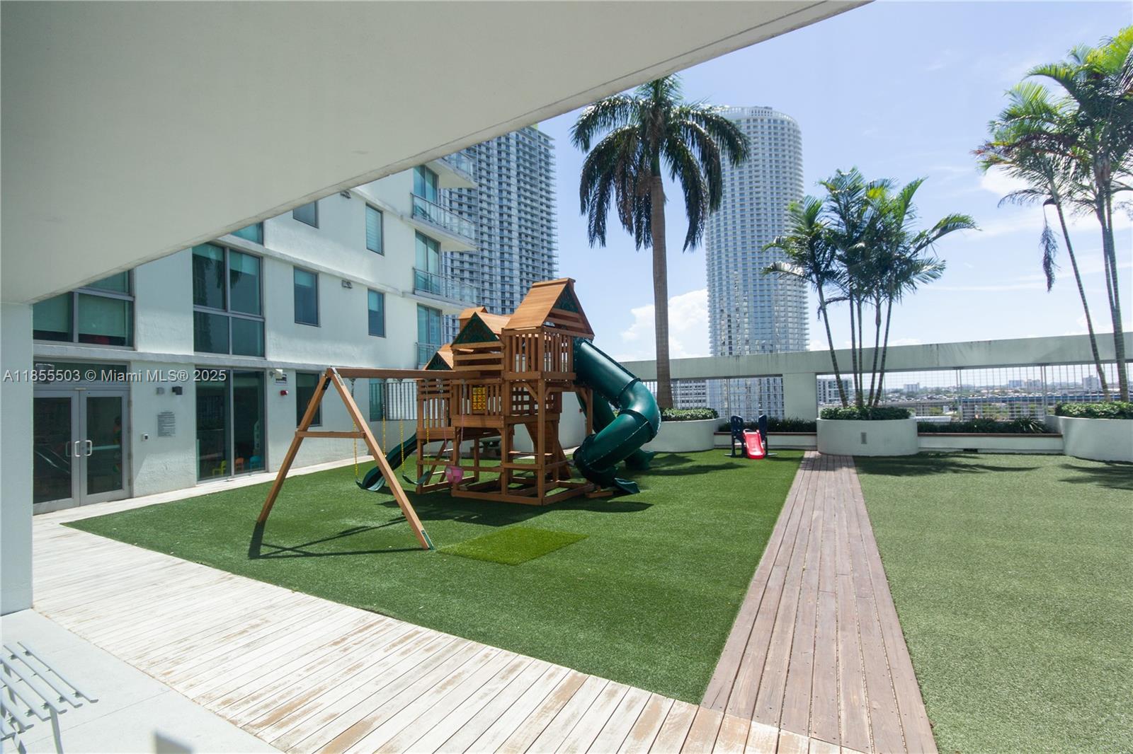 92 Southwest 3rd Street, Unit 1711 Miami, FL 33130 - Photo 39 of 54 a view of a backyard with a slide and a table