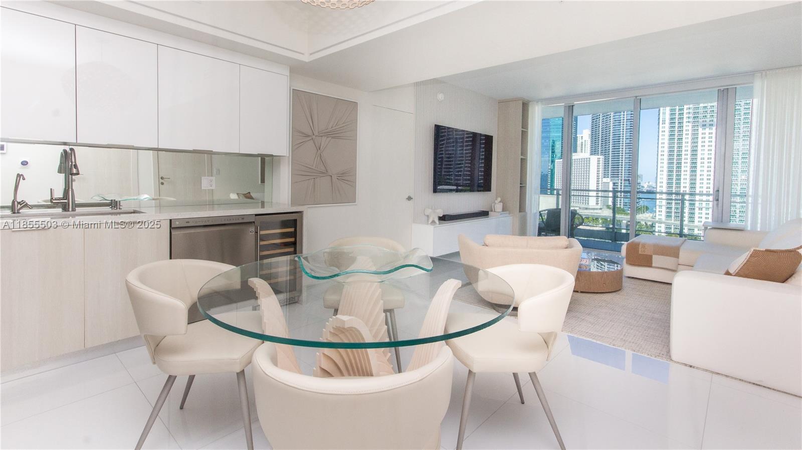 92 Southwest 3rd Street, Unit 1711 Miami, FL 33130 - Photo 7 of 54 a dining room with furniture a window and a kitchen view