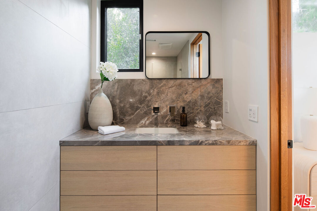 10326 Keswick Avenue Los Angeles, CA 90064 - Photo 28 of 38 a bathroom with a sink and a mirror