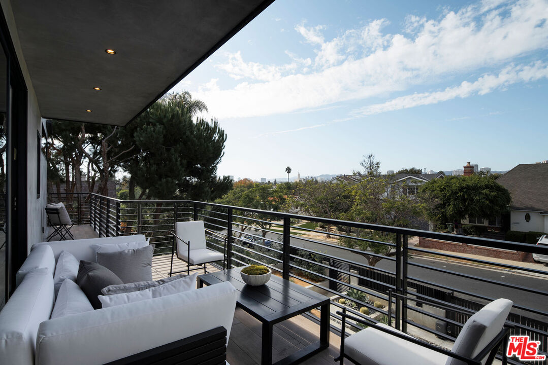 10326 Keswick Avenue Los Angeles, CA 90064 - Photo 31 of 38 a balcony with wooden floor and outdoor seating