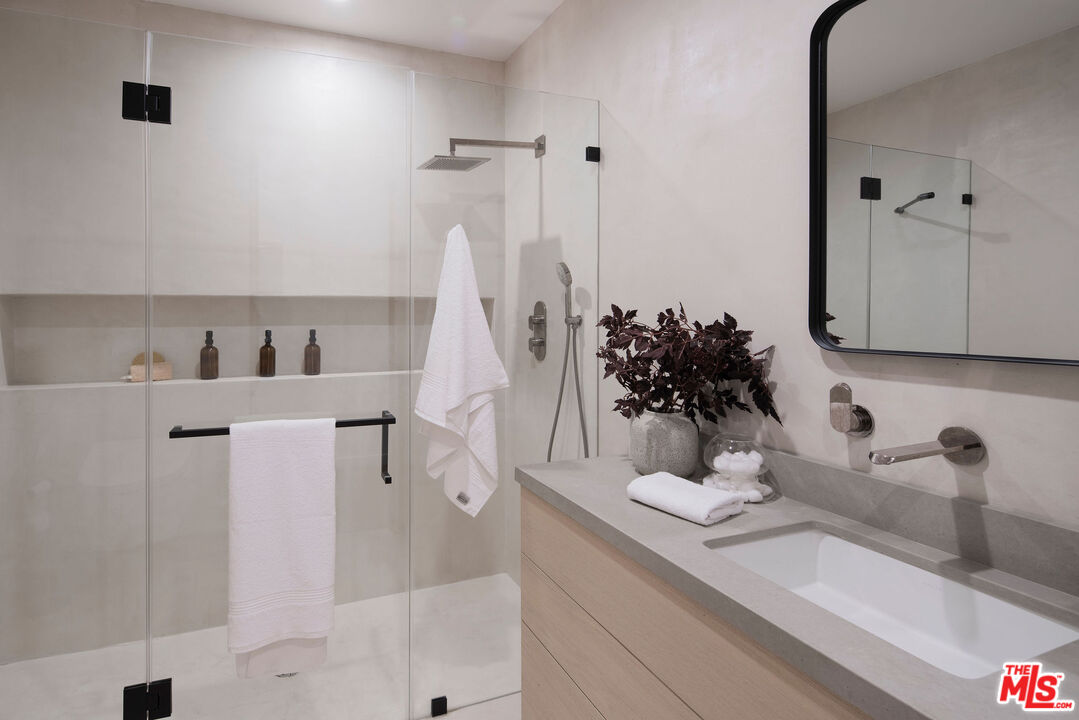 10326 Keswick Avenue Los Angeles, CA 90064 - Photo 36 of 38 a bathroom with a sink and a mirror